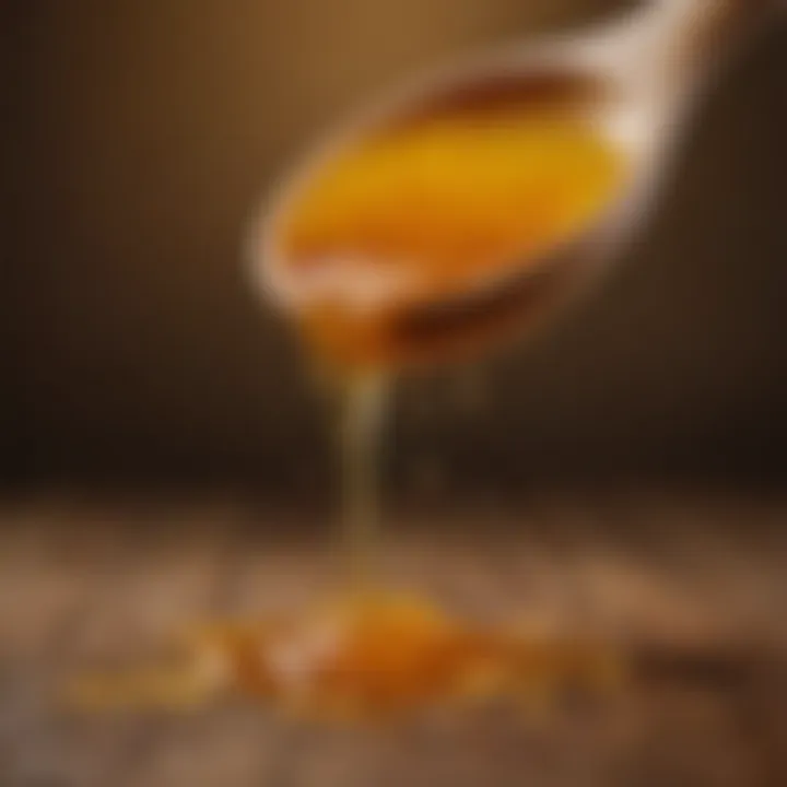 Honey being drizzled over a wooden spoon