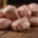 Raw chicken pieces placed on a wooden surface